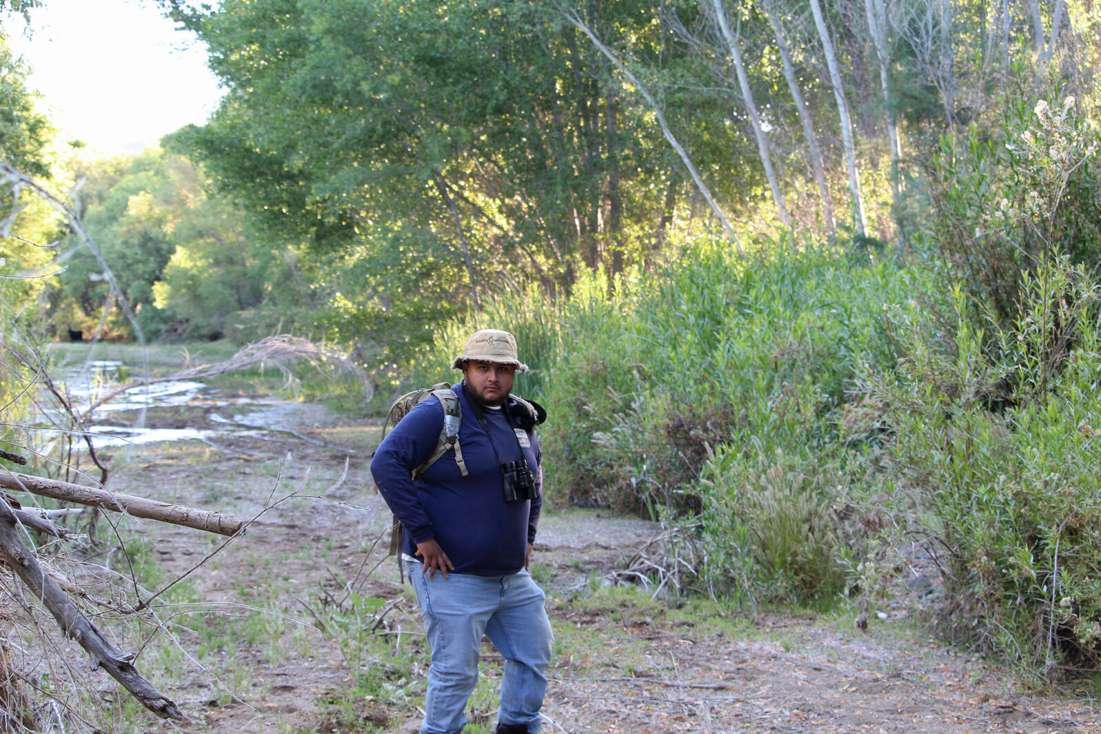 River Pathways intern Max Ayala poses with his field gear near the Agua Fria River.