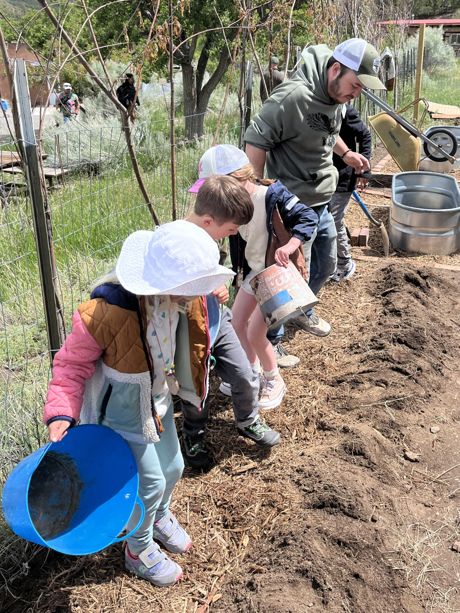 Campers help spread mulch in the new educational garden