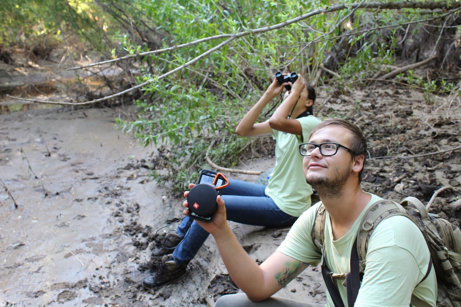 Daniel Hite and Nyah Torres, a River Pathways Intern, sit beside the Agua Fria River as they wait for a Western Yellow-billed Cuckoo to arrive.